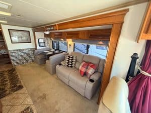 Comfortable RV living area with sofa, window, and decorative elements.