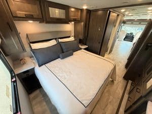 Comfortable bedroom in 2023 Coachmen Mirada 35OS RV for sale.