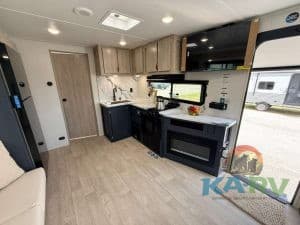 Interior of 2026 Acclaim 2500RD RV with kitchen and seating area.