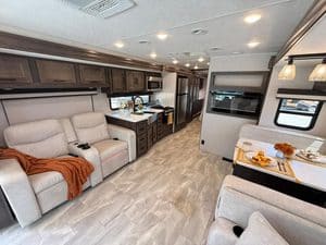 Interior of 2023 Coachmen Mirada 35OS RV with living area and kitchen.