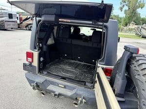 Open rear storage of 2016 Entegra Cornerstone 45B RV for repair or maintenance.