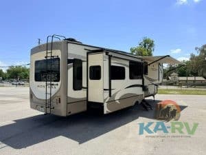 Luxury fifth wheel trailer with slide-outs and awning for optimal comfort.