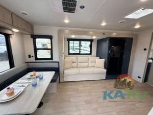 Modern RV interior with sofa and dining area in 2026 Acclaim 2500RD.