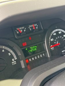 Close-up of vehicle dashboard showing fuel, temperature, and speedometer.