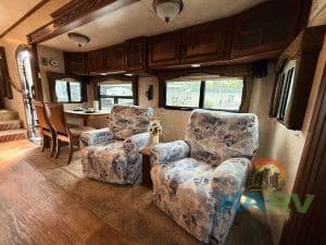 Comfortable RV living space with plush armchairs and ample natural light.