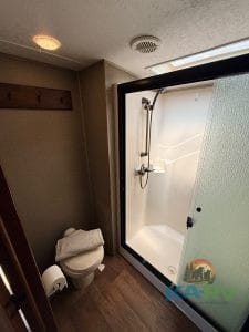 RV bathroom with shower, toilet, and privacy features for comfortable travel.
