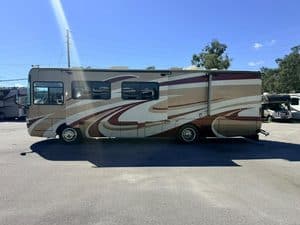 Spacious motorhome with beige and brown exterior at Karv Repair lot.
