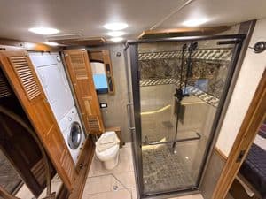 Bathroom in 2016 Entegra Cornerstone 45B RV with shower and toilet.