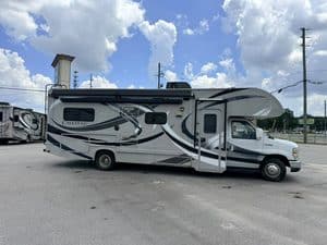 2014 Thor Chateau 28Z Class C RV parked outdoors under blue sky.