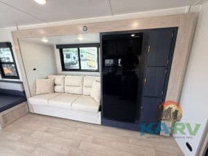 Interior of 2026 Acclaim 2500RD RV with sofa and storage cabinets.