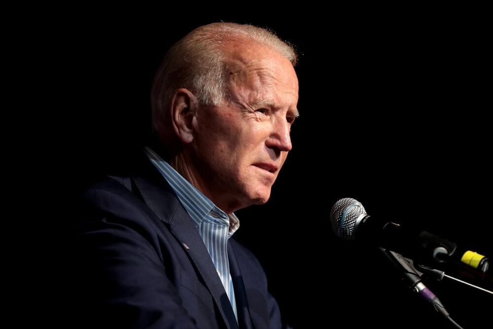 President Joe Biden speaks behind podium