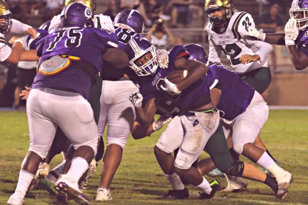 Gainesville's Caleb Young runs against Trinity Catholic on Thursday.