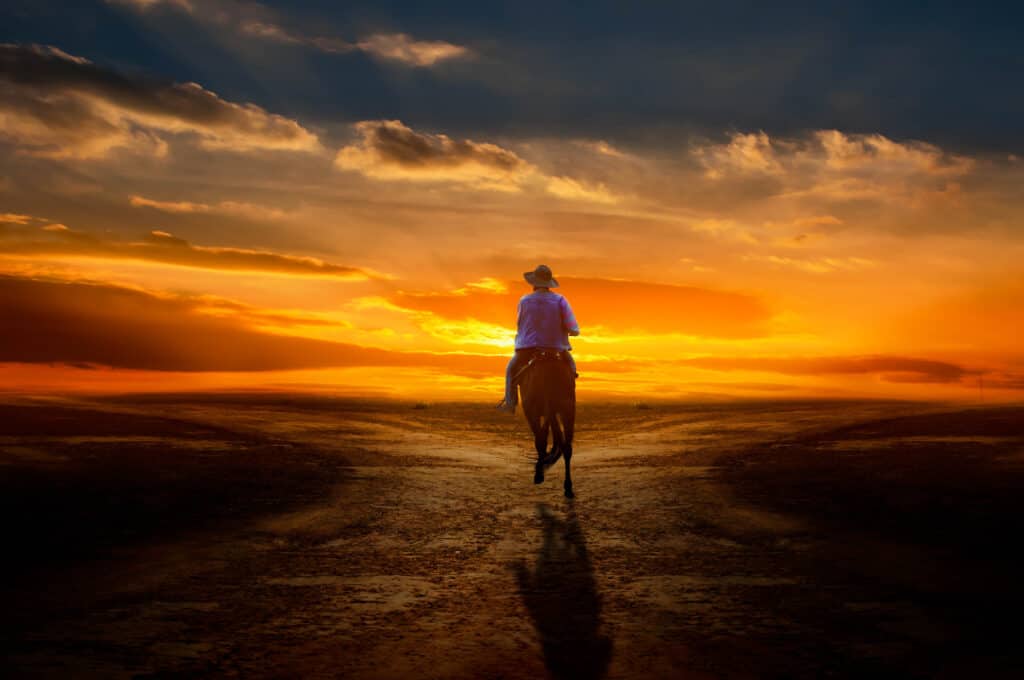 Cowboy riding into the sunset