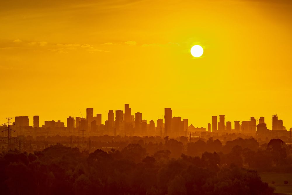 Sun over city skyline heat wave