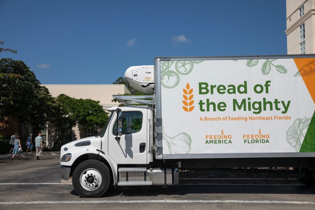 A Bread of the Mighty Food Bank supply truck sits parked outside the Hilton UF Conference Center.