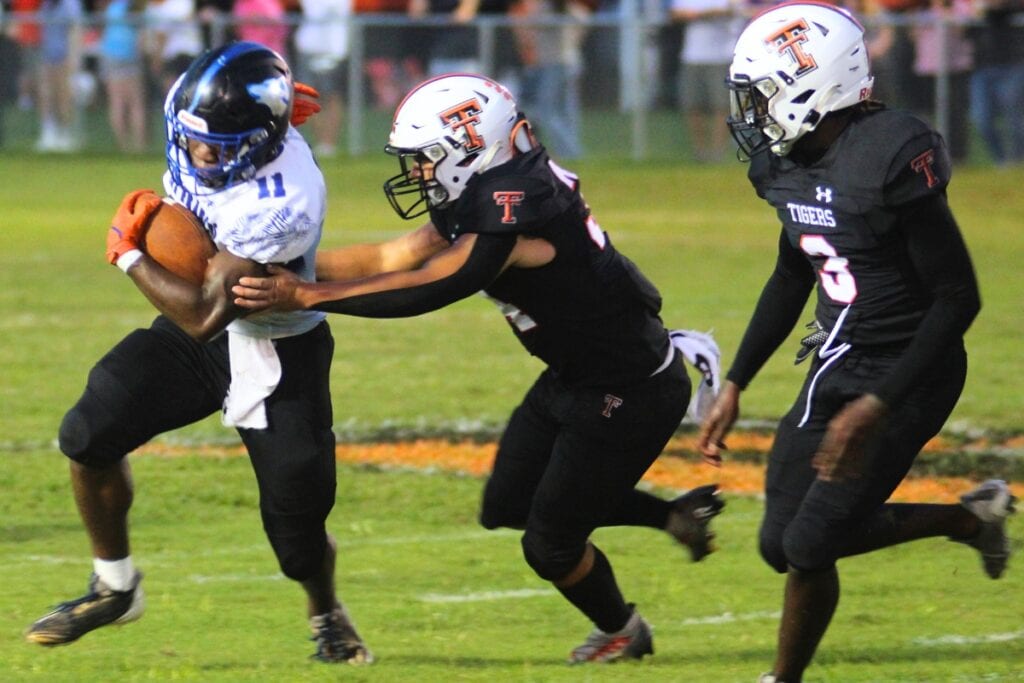 Trenton defenders close in on St. Francis Catholic's Devin Rollins on Friday.