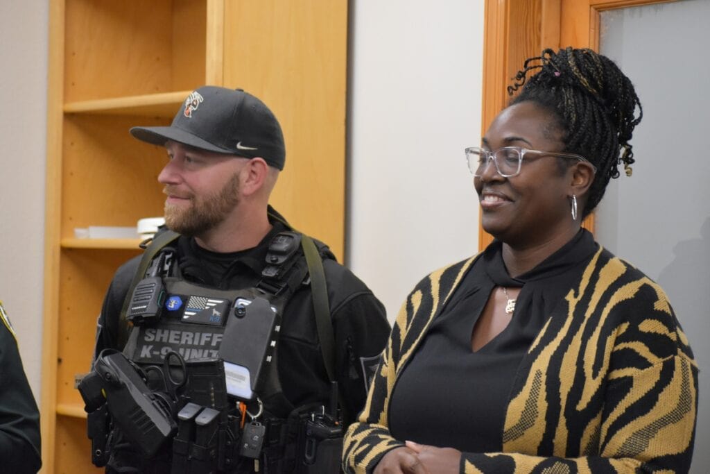 Hawthorne Mayor Jacquelyn Randall (right) talks with an Alachua County Sheriff's K-9 deputy at Tuesday's grand opening.