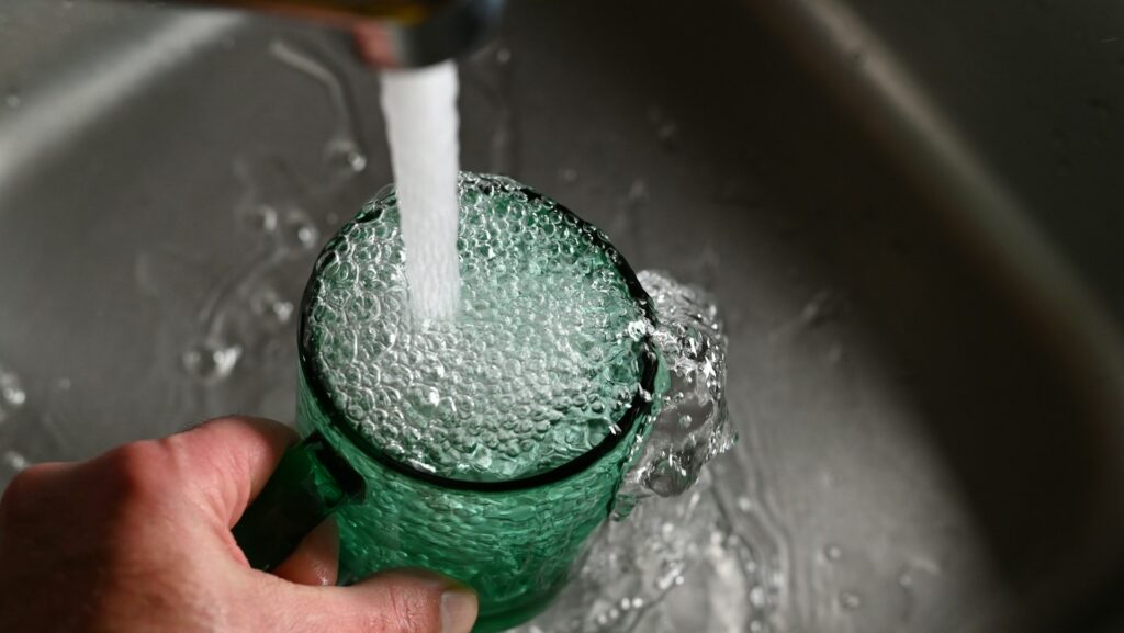 tap water fills a cup
