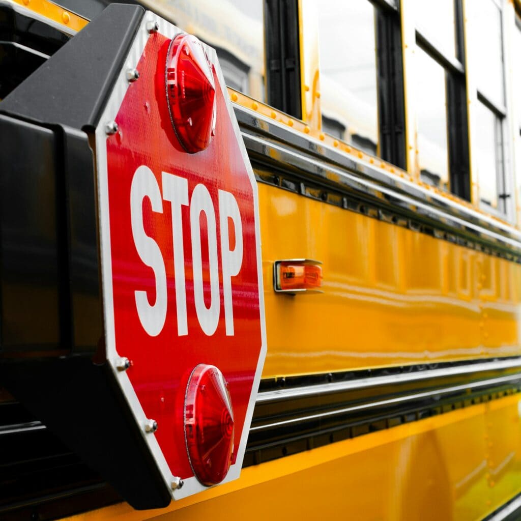 stop sign on the side of a school bus
