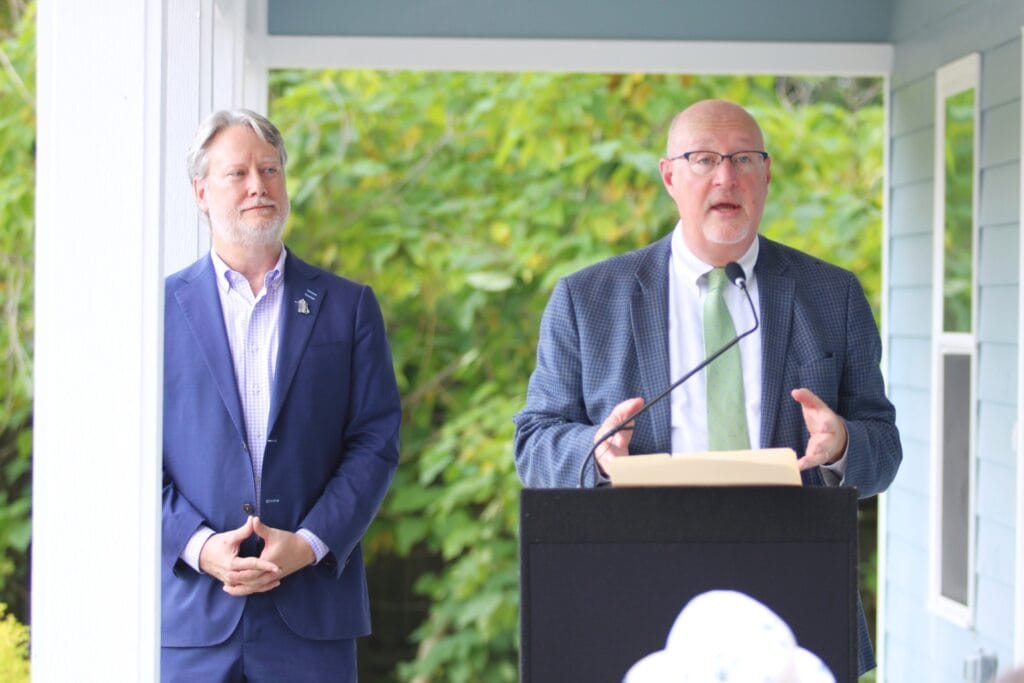 Mayor Harvey Ward speaks at the ribbon cutting for the new home in partnership with Bright Community Trust, with President Frank Wells (left).