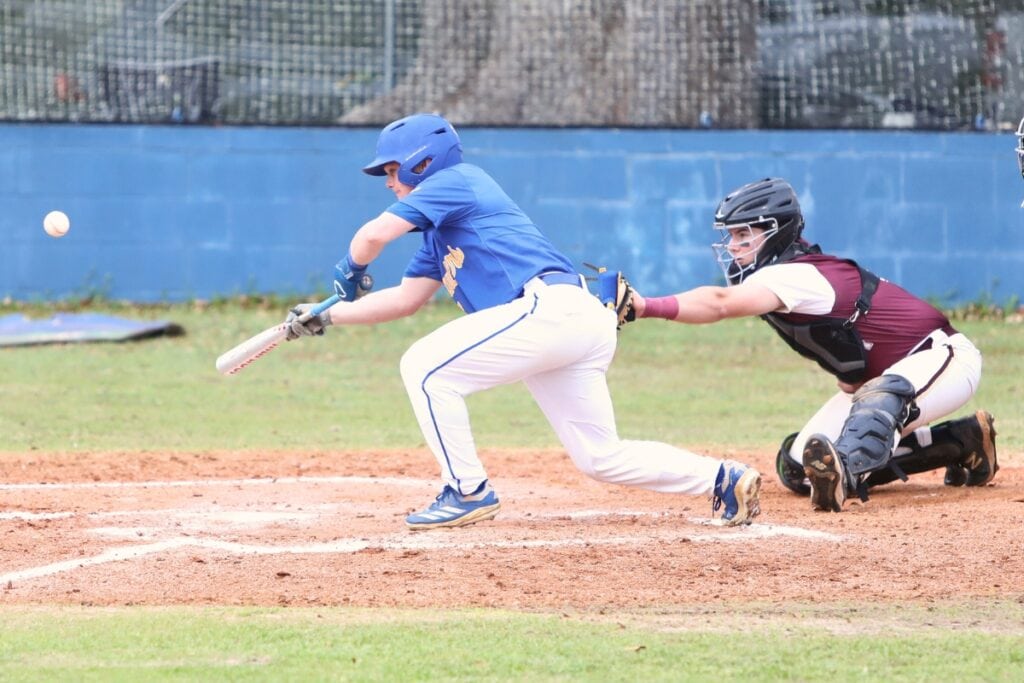 Newberry's Brycen Ochs (7) with a third-inning bunt against Oak Hall. Photo by C.J. Gish