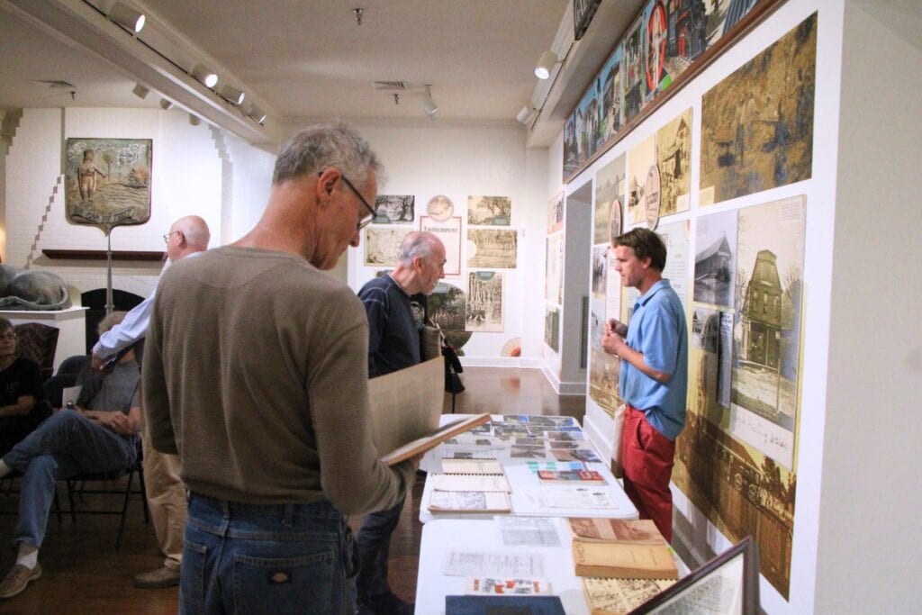 A presentation attendee reads through documents used to research the North Main Street buildings. Photo by Lillian Hamman