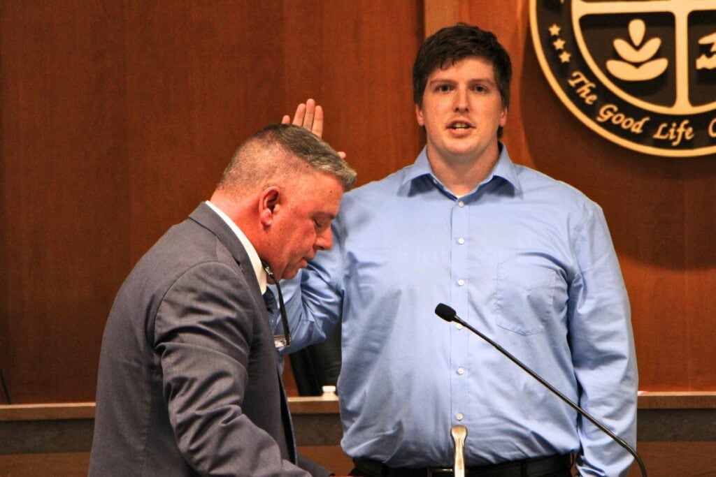 Alachua City Manager Mike DaRoza swears in Commissioner Jacob Fletcher. Photo by Lillian Hamman