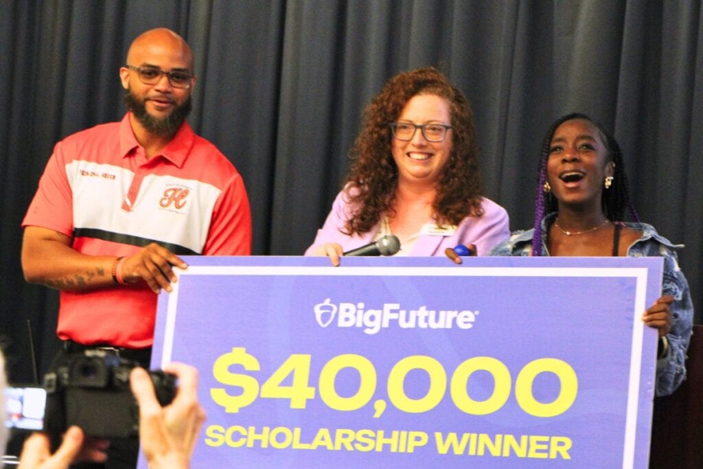 Hawthorne principal John Green (left) and the College Board's Stephanie Tate (center) celebrates Melody Watson's (right) scholarship win. Photo by Lillian Hamman (1)