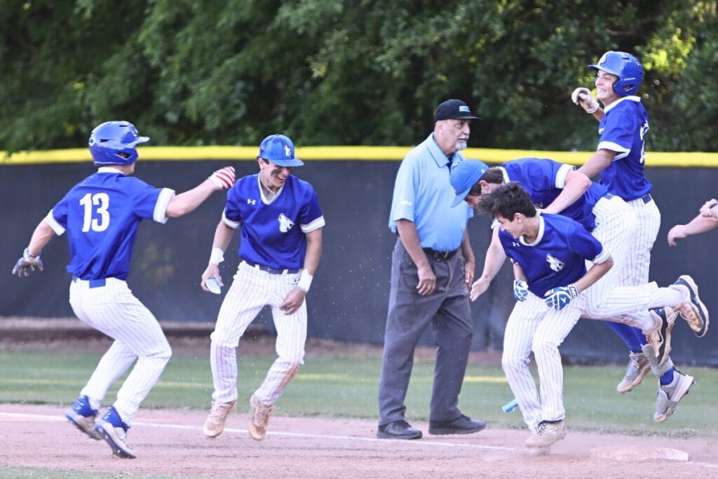 St. Francis Catholic celebrates after Cyrus Fariborzian hit a walk-off RBI single in the bottom of the seventh inning to win the Class 1A-District 5 championship game, Photo by C.J. Gish
