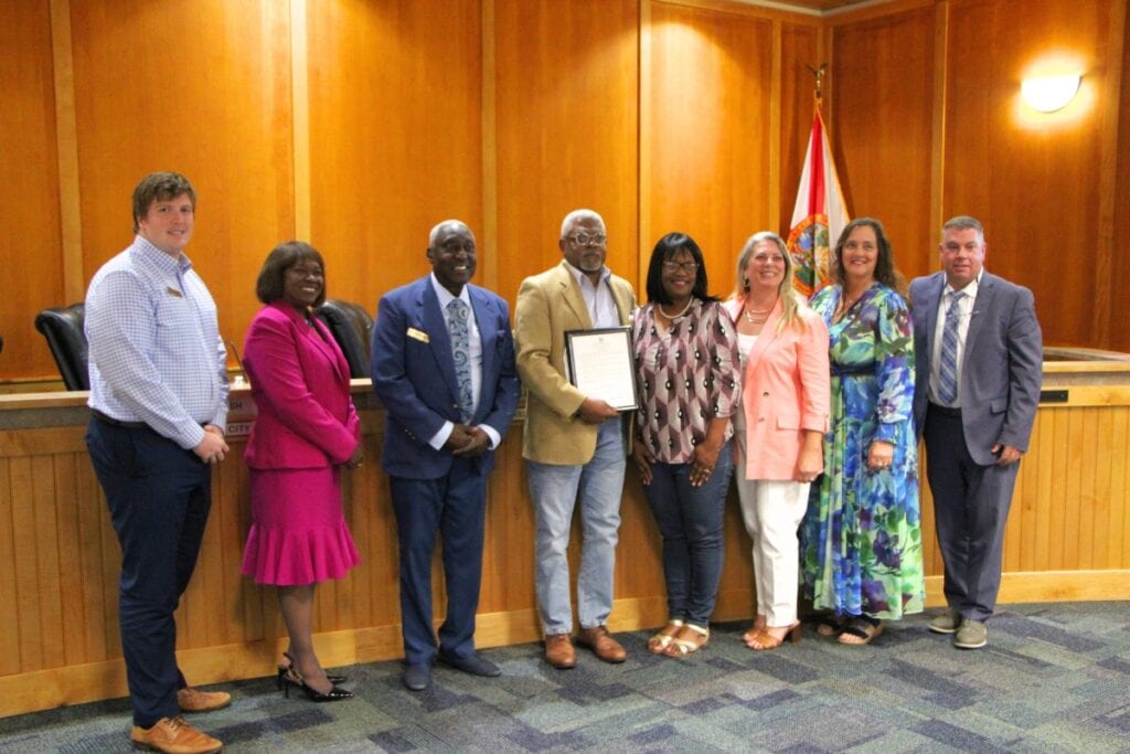 Alachua County Poet Laureate E. Stanley Richardson accepts the Alachua City Commission's National Poetry Month proclamation.