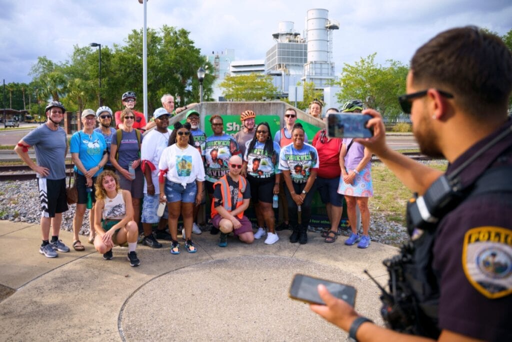 Attendees at the Ride of Silence pose for a photo taken by a UFPD officer in Gainesville's Depot Park on Wednesday. Photo by Tim Rodriquez