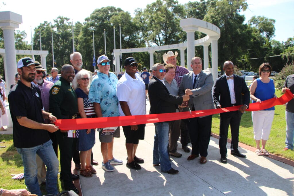 Officials gather to cut the ribbon the Veterans Memorial Park.