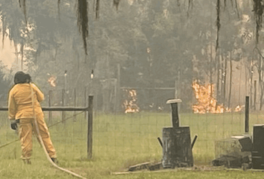 Fire personnel battle brush fire near County roads 225 and 1475