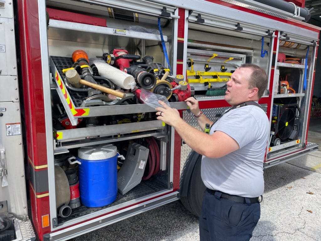 Firefighter Kyle Livingston checks through the fire trucks supplies. Photo by Seth Johnson