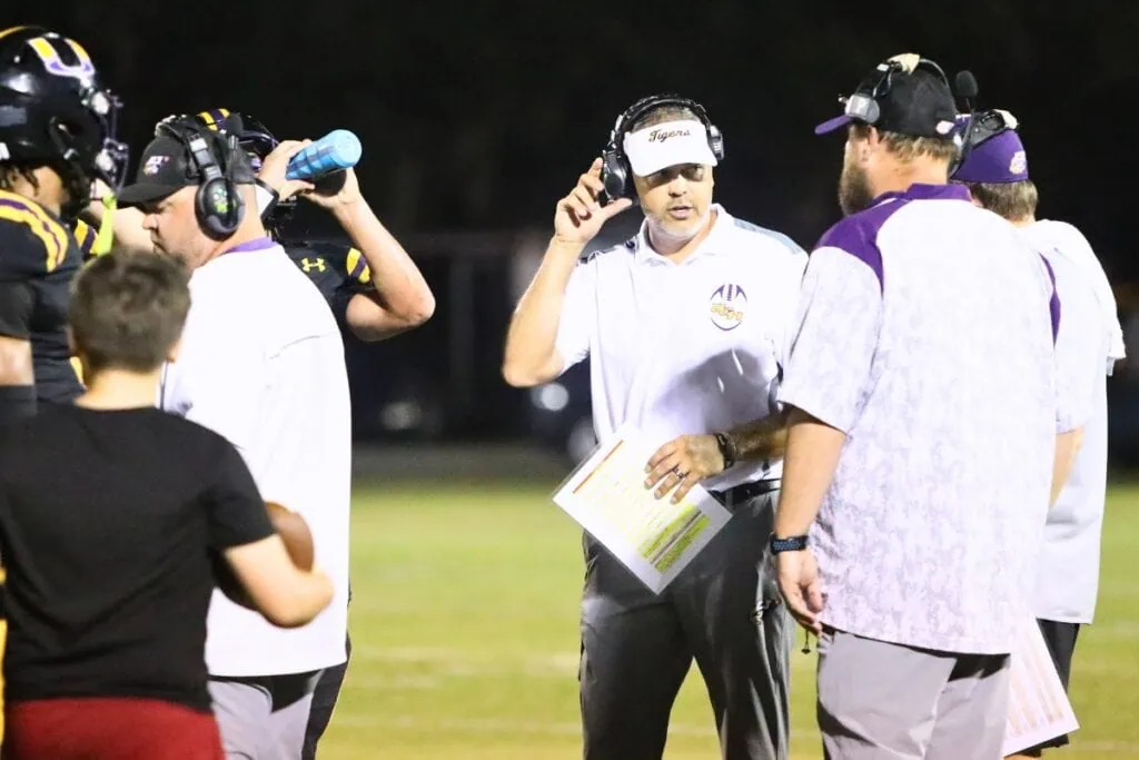 Andrew Thomas (center talking) was fired as the Union County High School football coach and athletic director on May 29. Photo by C.J. Gish