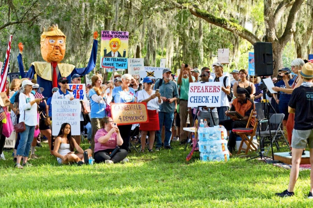 Protesters gathered in Cora Roberson Park in Gainesville for the No Kings Day rally on Saturday.