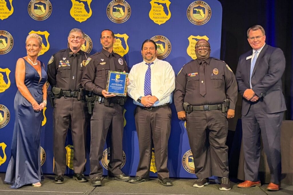 Santa Fe College Police Chief Ed Book (second from left) and members of the Santa Fe College Police Department accept the Rocky Pomerance Award in June 2025. Courtesy Santa Fe College