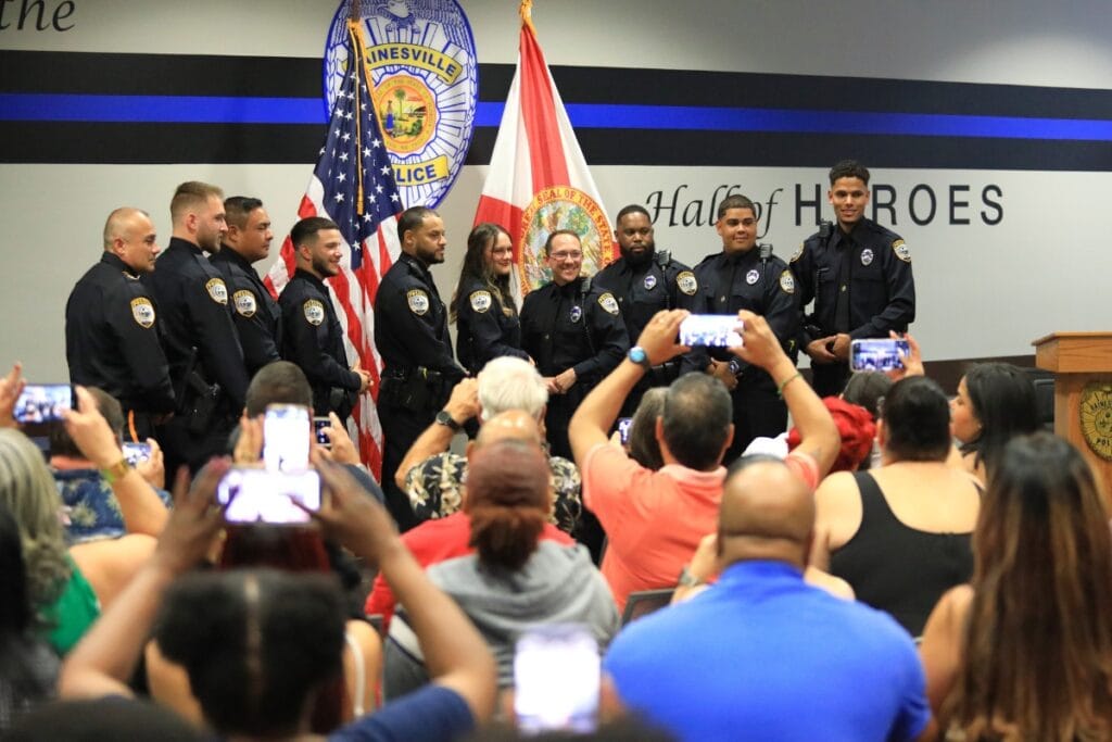 The Gainesville Police Department swore in nine new officers on Friday, standing in front of family and friends along with Chief Nelson Moya, far left.