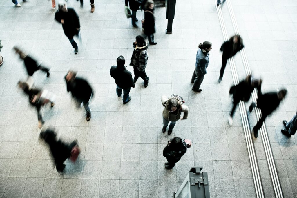 People walk in a busy plaza.