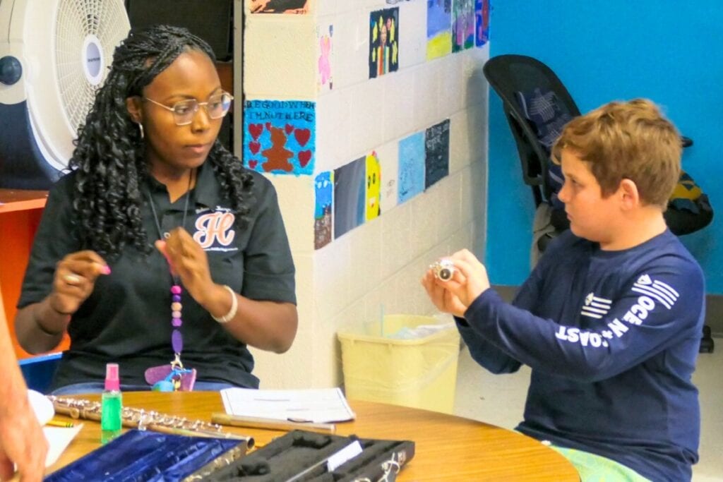 Kristi Neal teaches students how to hold the flute. Courtesy of ACPS