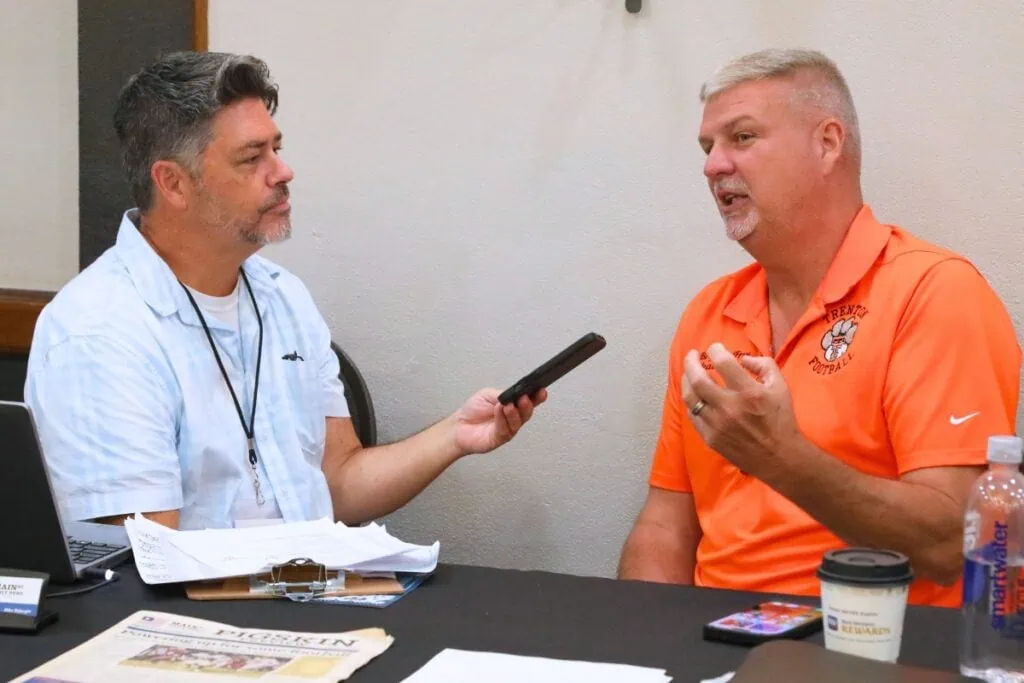 Mainstreet Sports Director Mike Ridaught (left) interviews Trenton coach Bryant Frye at the North Central Florida High School Football Media Day on Thursday.