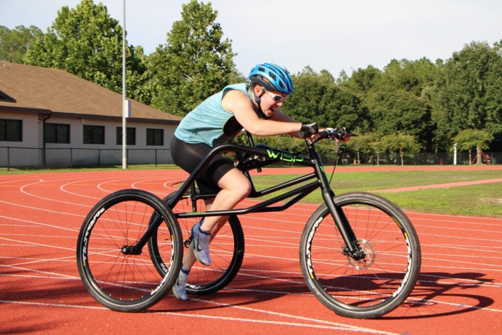 Sayers Grooms focuses on turn over during a summer sprint workout at Fred Cone Park track. Photo by Lillian Hamman