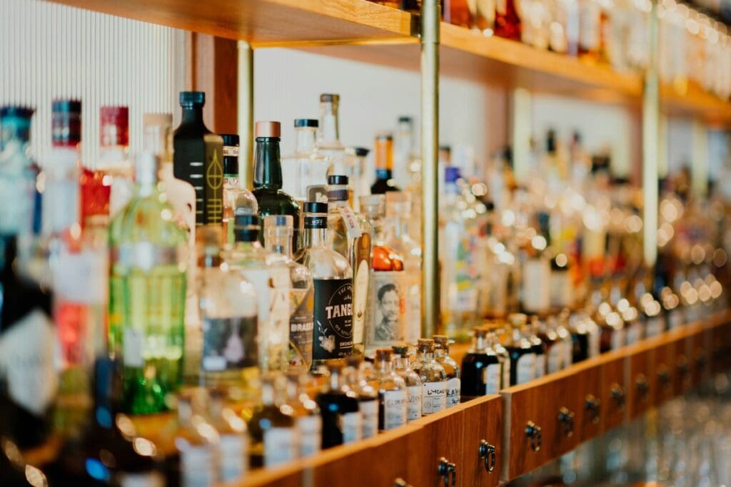 Alcohol bottles in bar. Photo by Chuttersnap-Unsplash