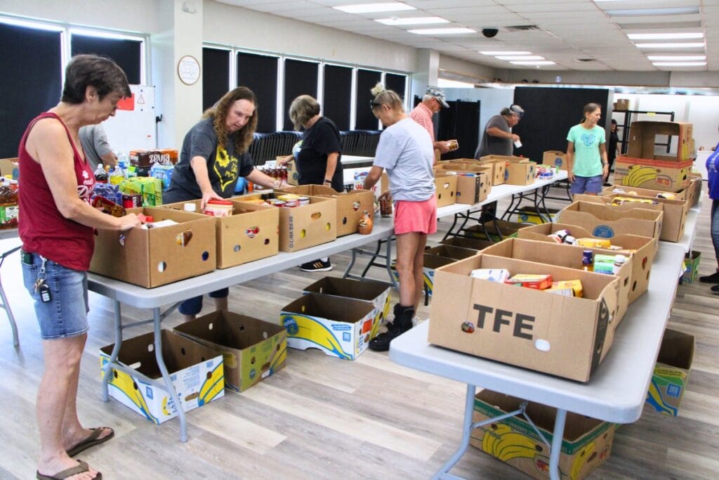 Around 20 volunteers restock Deeper Purpose's food pantry after reopening in August 2025.