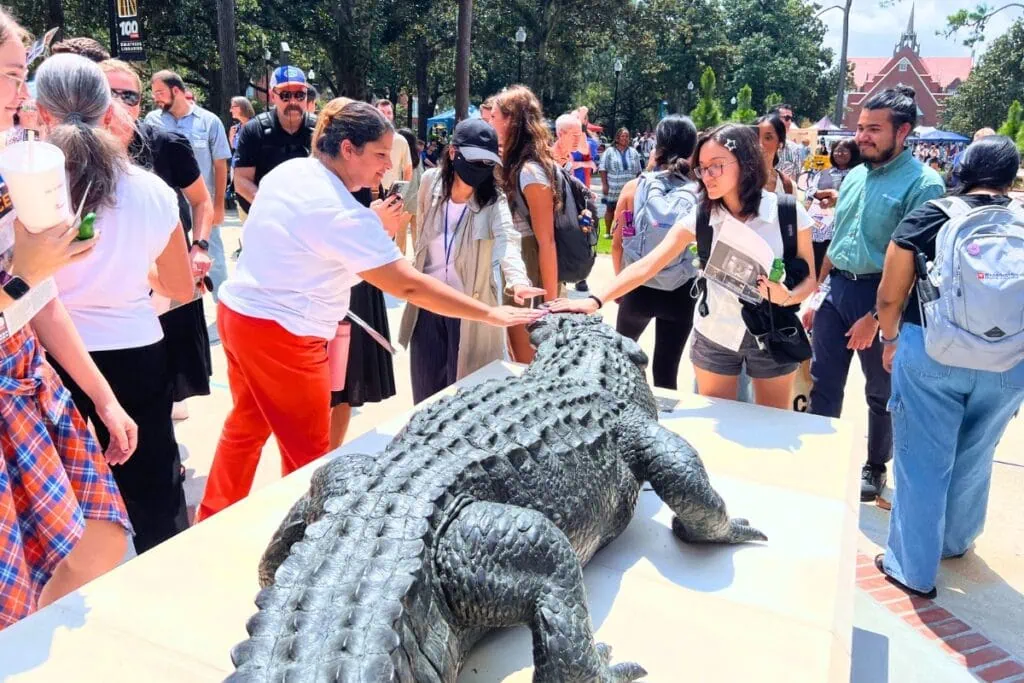 Attendees pat the nose of Focused Attention following its unveiling Thursday afternoon. Photo by Nick Anschultz