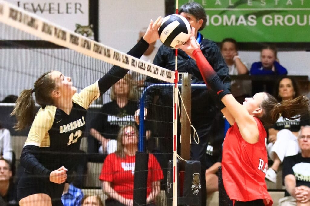 Buchholz's Taylor Sembower (12) and Santa Fe's Ella Schneider (5) battle at the net. Photo by C.J. Gish