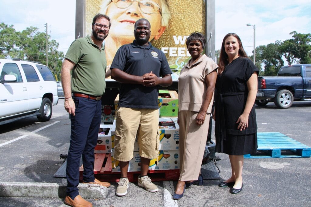 (From left) Patrick Dodds from Bread of the Mighty, Adam Joy of Deeper Purpose Community Church, Ester Tibbs and Lesley Banis of the Community Foundation of North Central Florida welcome a delivery