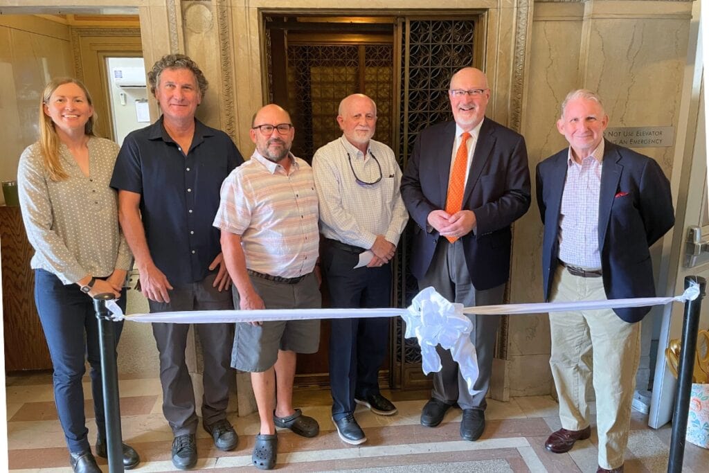 Officials gather to celebrate the restoration of the Hippodrome Theatre's elevator, a project that took a combination of city, theatre and community effort. Photo by Seth Johnson