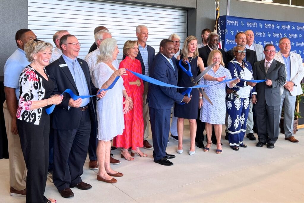 Santa Fe College President Paul Broadie II, members of the District Board of Trustees, Foundation, legislative delegation and Jerry Cellon prepare to cut the ribbon on Tuesday morning.