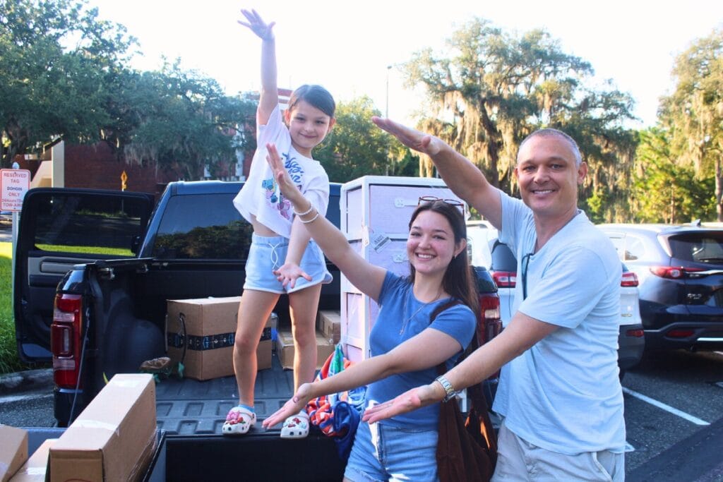 The Skoroz family does the gator chomp during UF Fall move-in on Saturday morningThe Skoroz family does the gator chomp during UF fall move-in on Saturday morning. Photo by Nick Anshultz